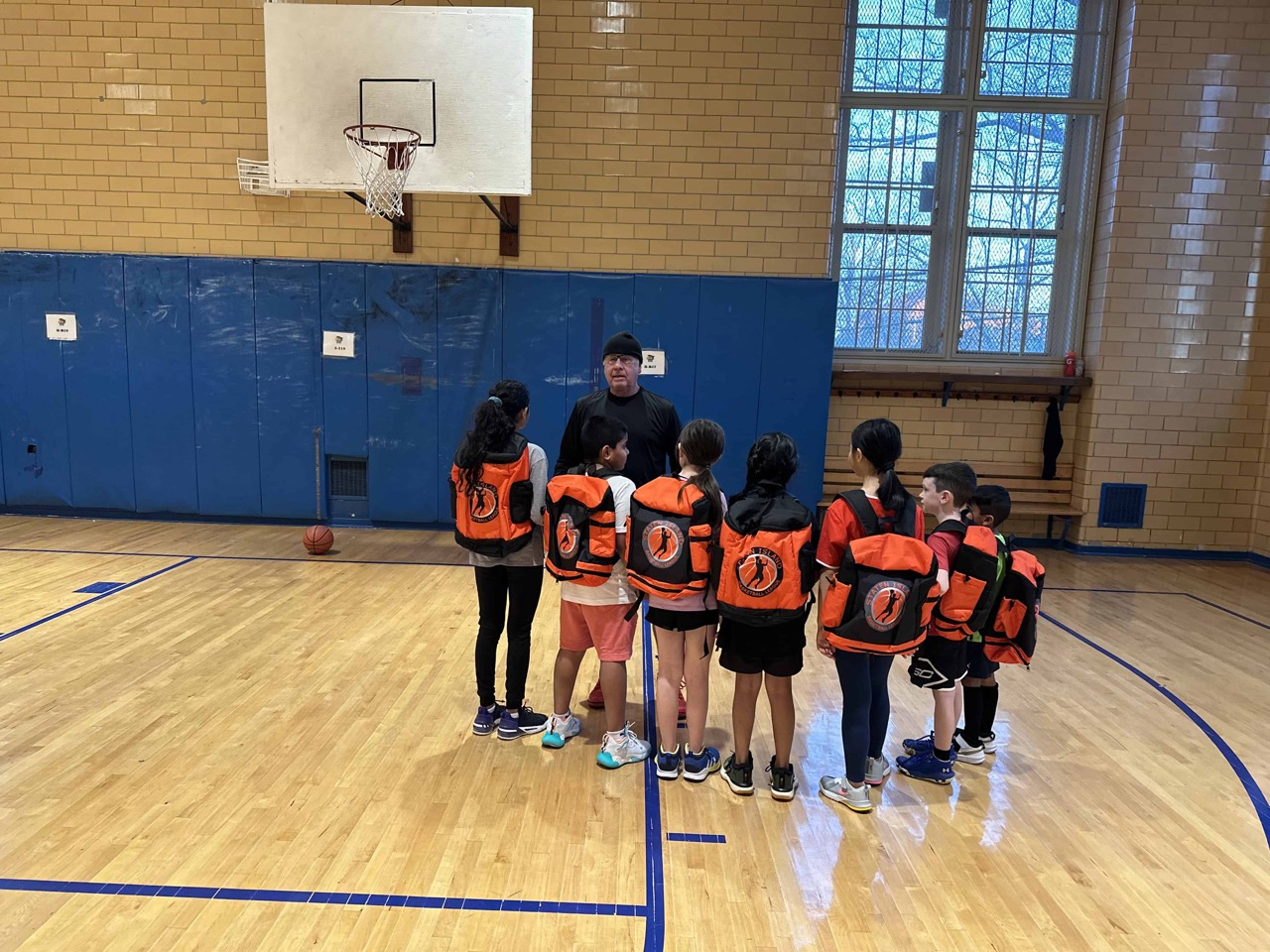 Children’s basketball instructional group wearing the new SIBL back pack with the Commissioner 3/23